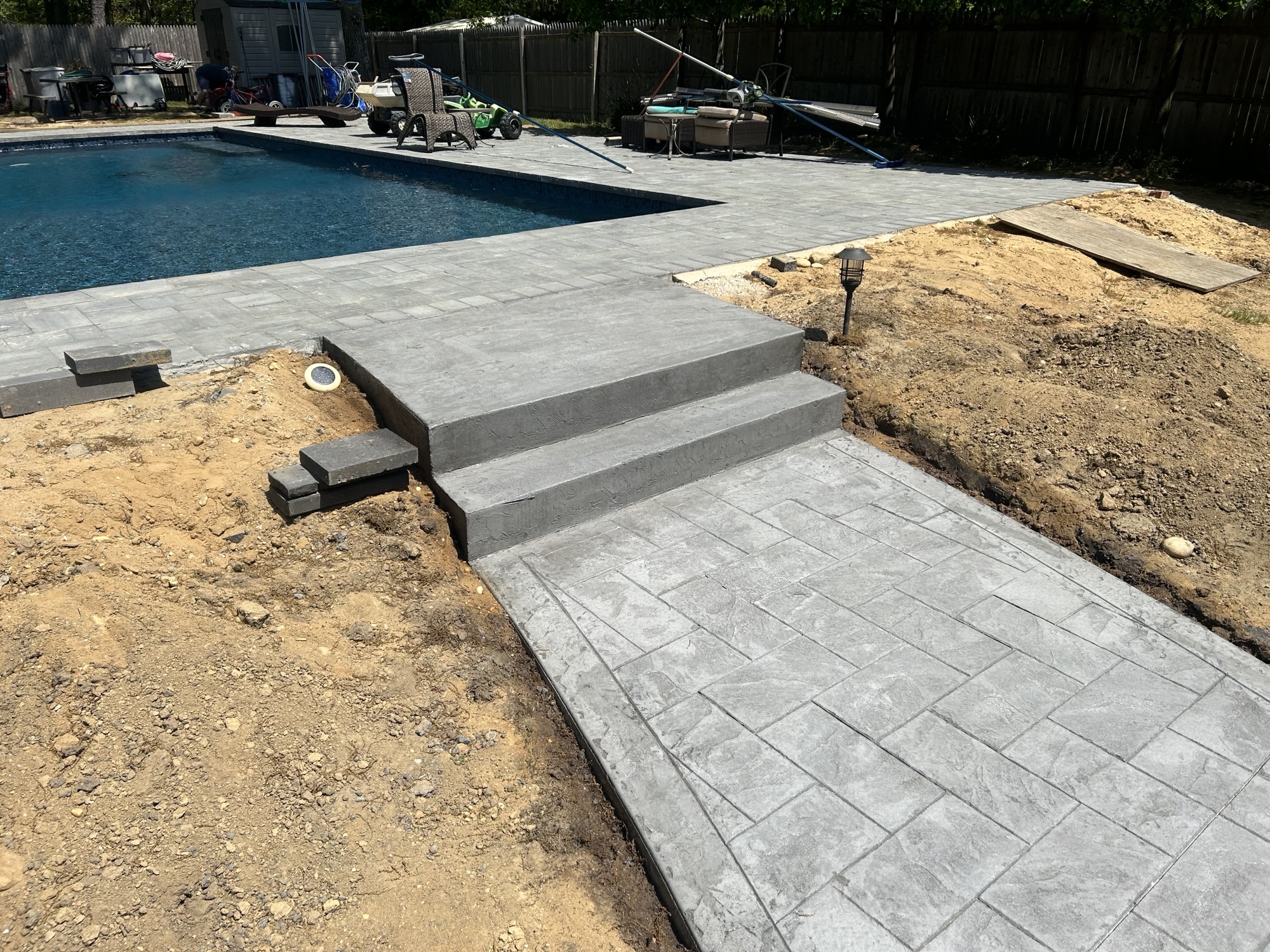 Concrete pool patio with custom steps