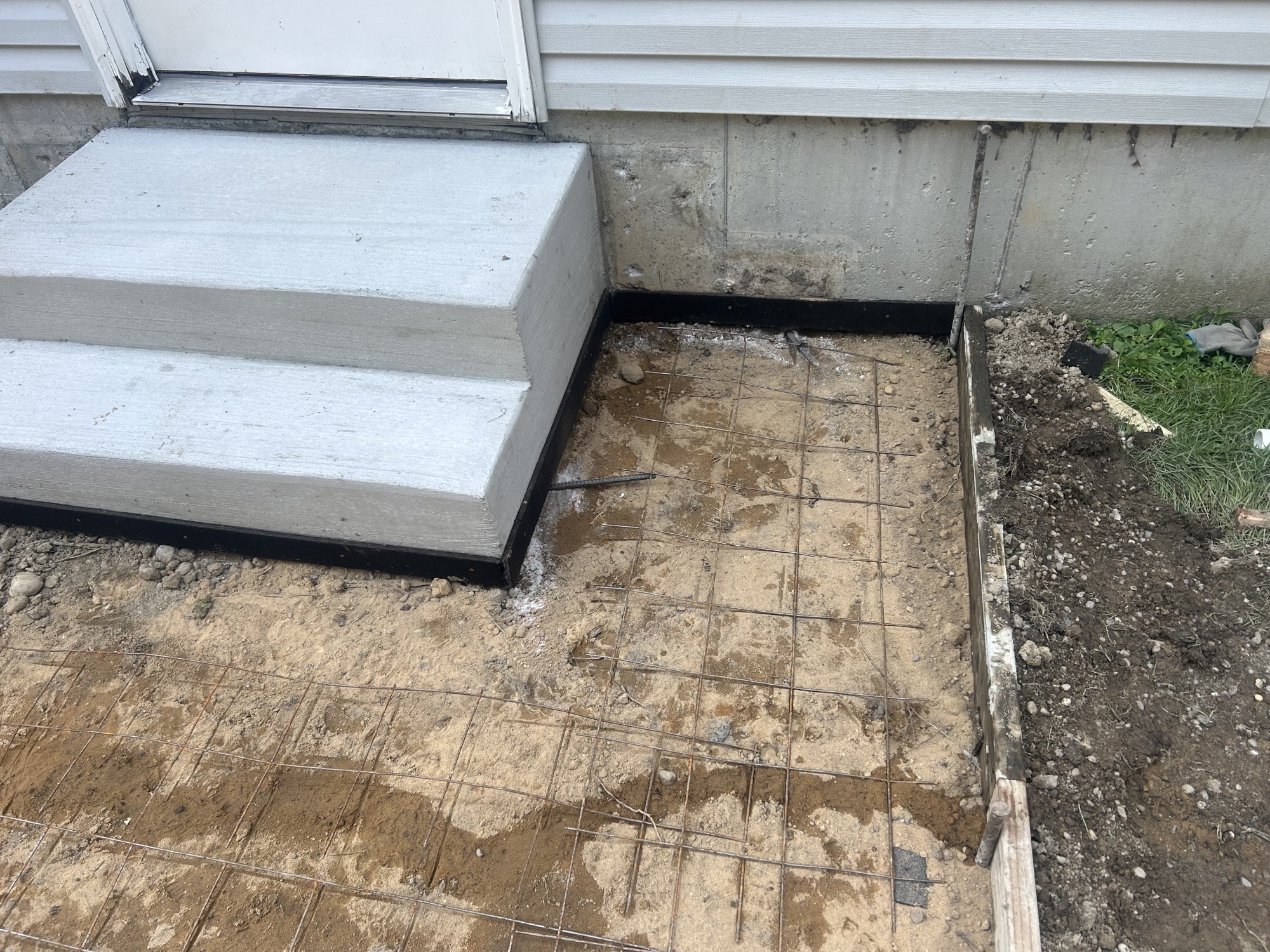 Poured entry steps with patio prep underway