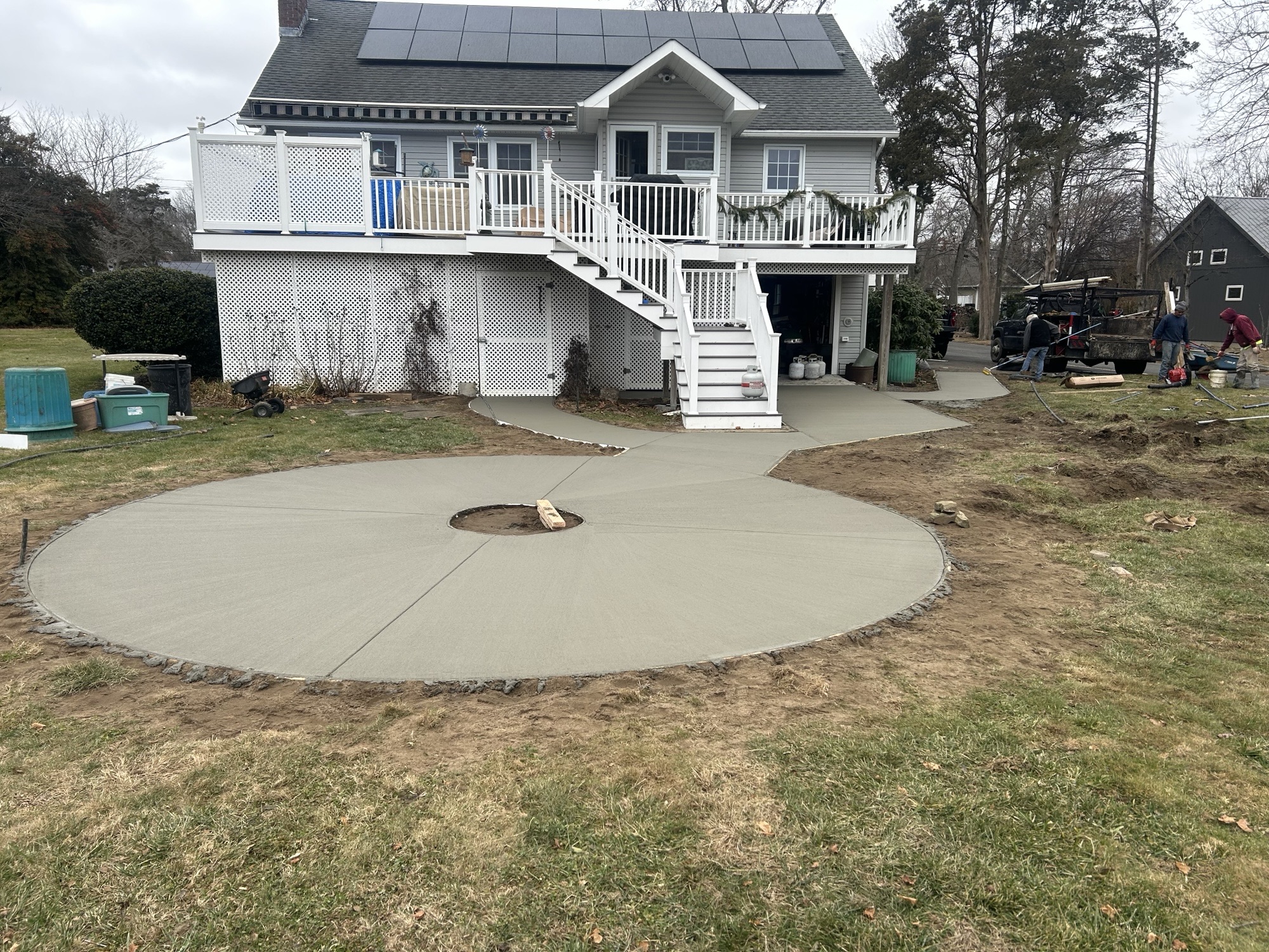 Circular concrete fire-pit patio and walkways